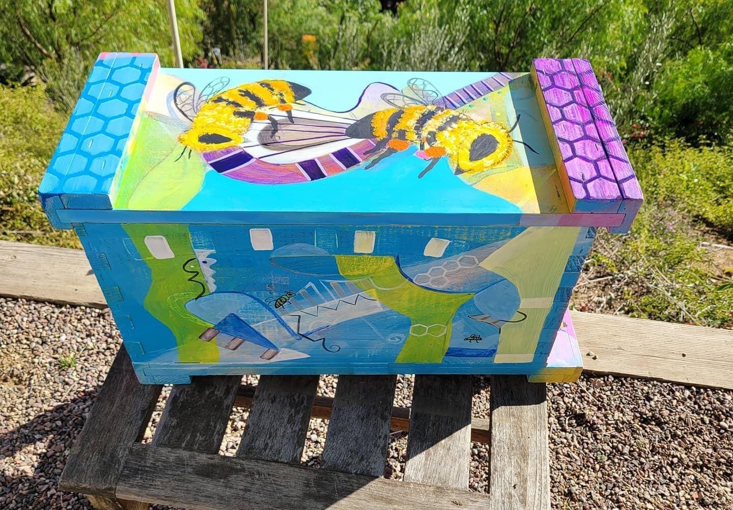 Beecasso teal bee box with large painted honeybee across the top panel and honeycomb end caps